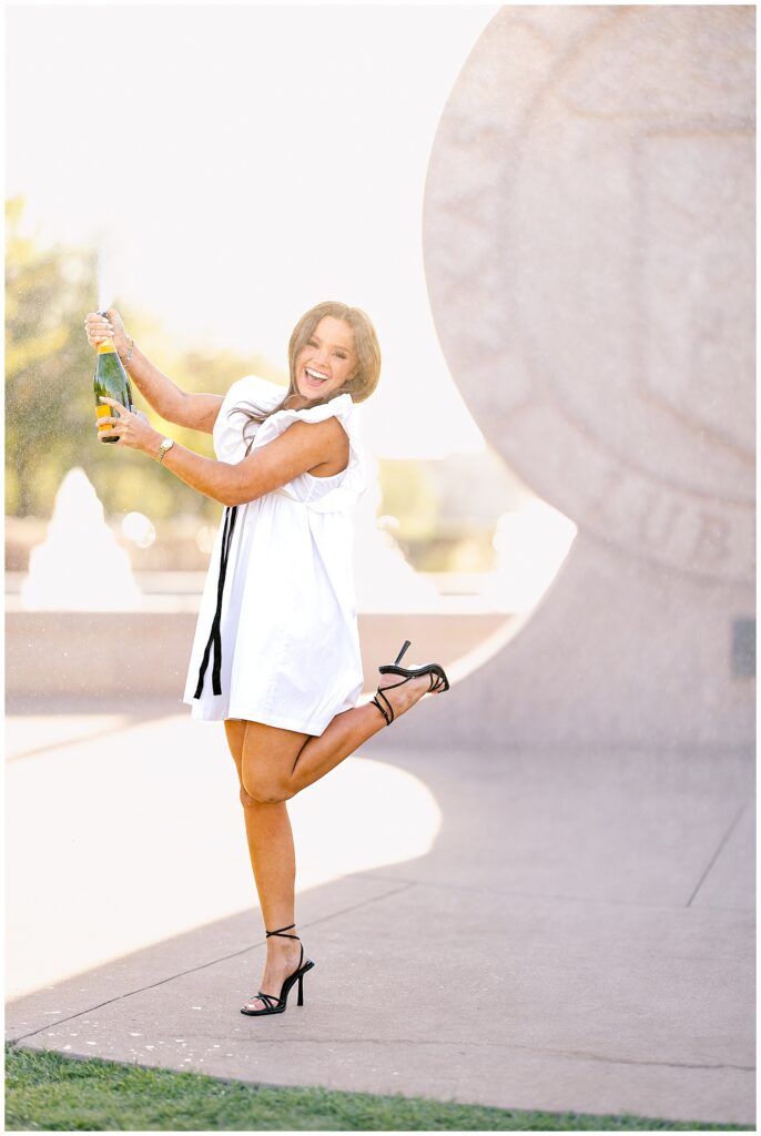 Texas Tech senior popping champagne at the seal